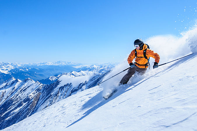 person skiing down snowy mountain