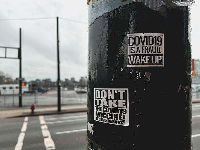 An anti-vaccine poster on a street pole reading