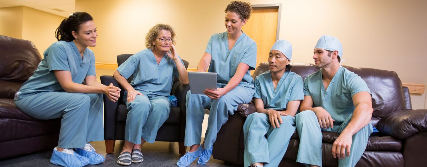 group of doctors sitting together looking at a screen