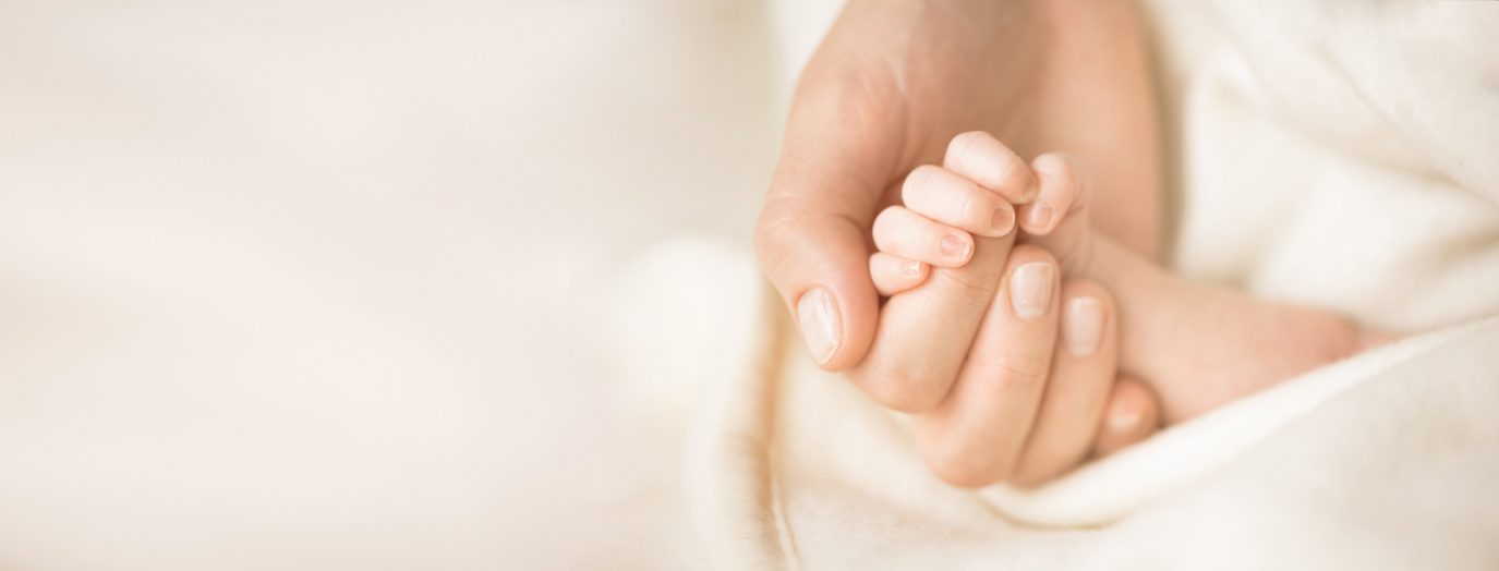 person holding baby's hand