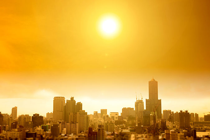 hot city landscape with blazing sun in sky