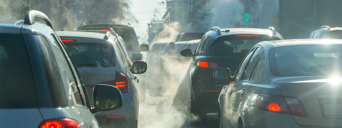 cars in traffic with visible exhaust fumes